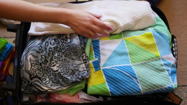 girl puts things in the suitcase for travel in closeup - Footage, Video
