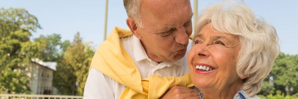Senior man kissing his wife - Photo, image