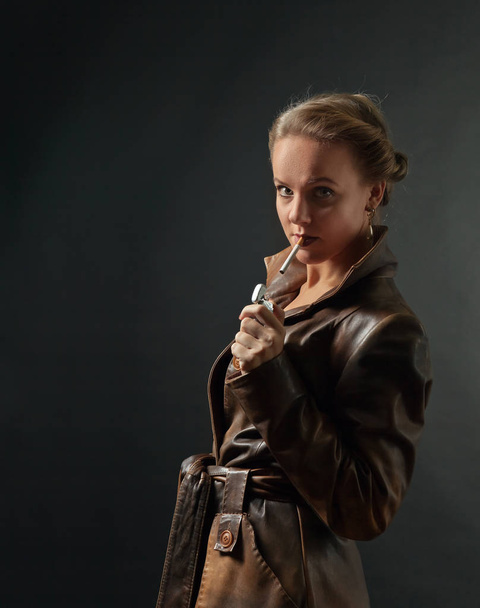 Portrait of young beautiful woman in brown leather coat - Фото, зображення