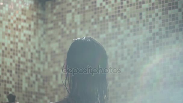 Beautiful nude woman relaxing in spa. Girl with bikini washes stream of water - Felvétel, videó