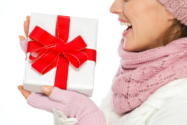 Closeup on Christmas present box in hand of woman in winter clot - Fotó, kép