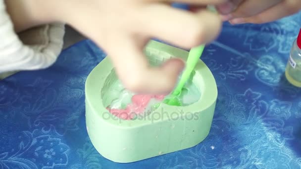 Womans hands pouring soap base to the template with dropper for handmade soap creation - Video