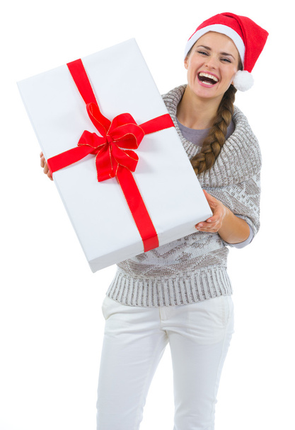 Happy woman in Santa hat holding big Christmas present - Foto, afbeelding
