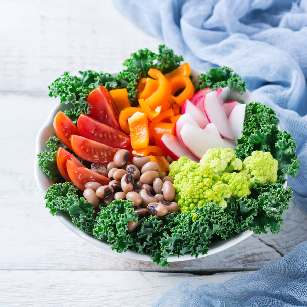 Healthy vegan buddha bowl with kale leaves and raw vegetables - Photo, Image