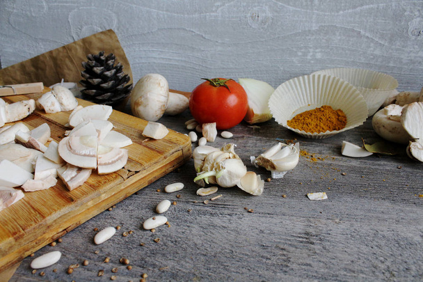 Grey wooden table with vegetables, onions, mushrooms, peppers, a - Photo, Image