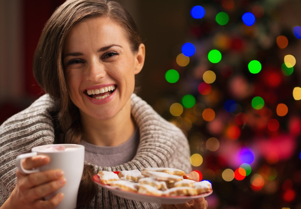 Happy woman holding cup of hot chocolate with marshmallows and p - Zdjęcie, obraz