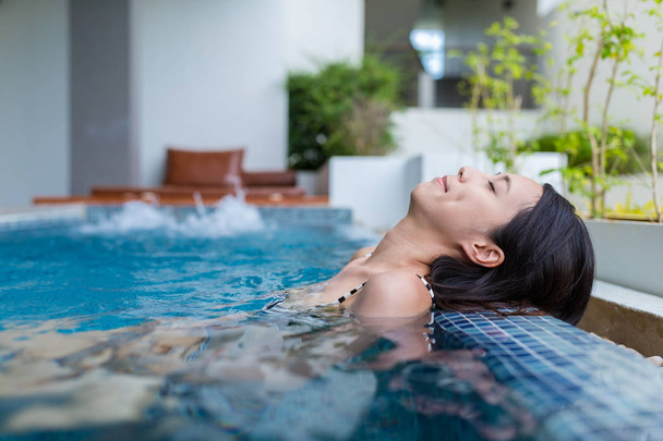 Woman relaxing in jacuzzi pool  - Φωτογραφία, εικόνα