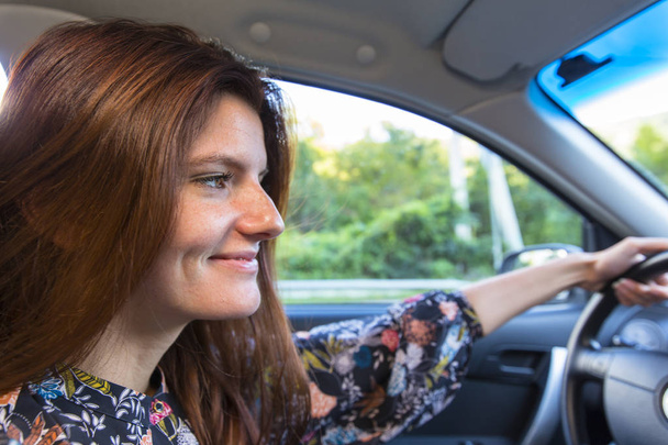 Attractive young woman driving car - Fotó, kép