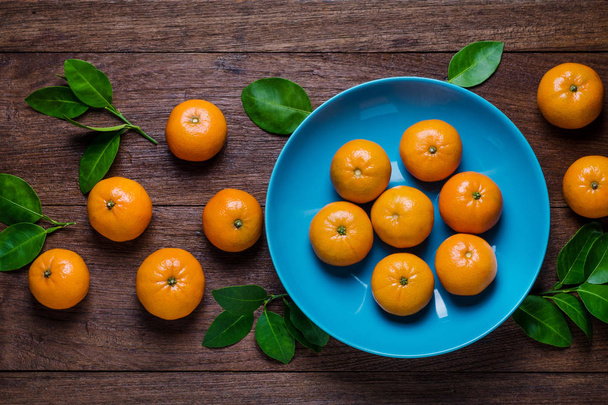Fresh orange fruits on  table. Top view - Zdjęcie, obraz