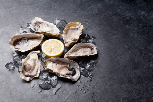 Oysters and lemon on table - Photo, Image