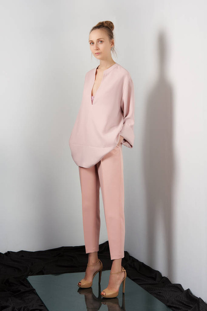 Fashion model in peach slim pants and blouse  - Foto, immagini