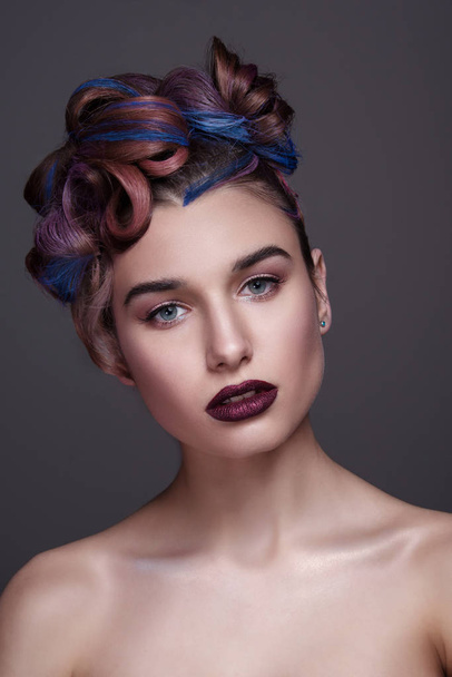 Beautiful girl with bright creative fashion makeup and colorful hairstyle. Studio portrait of beauty face. - Foto, Imagen