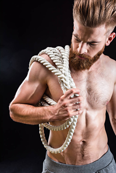 sportsman holding rope - Фото, изображение