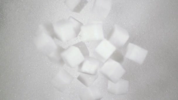 Kostki cukru spada w dół na cukier. Slow mo, widok z góry - Materiał filmowy, wideo
