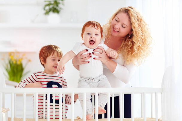 happy mother enjoying maternity, playing with kids at home - Zdjęcie, obraz