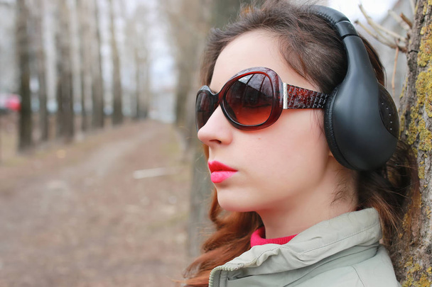 жінка з навушниками в парку осінь
 - Фото, зображення