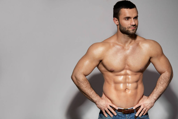 Handsome Smiling Young Man With Sexy Fit Muscular Body Indoors - Фото, изображение