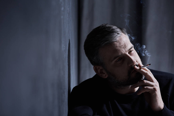 Man smoking a cigarette - Fotó, kép
