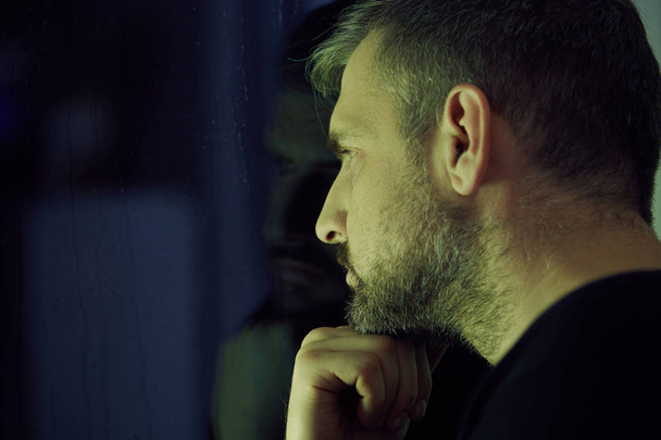 Man thinking and looking through the window - Фото, зображення