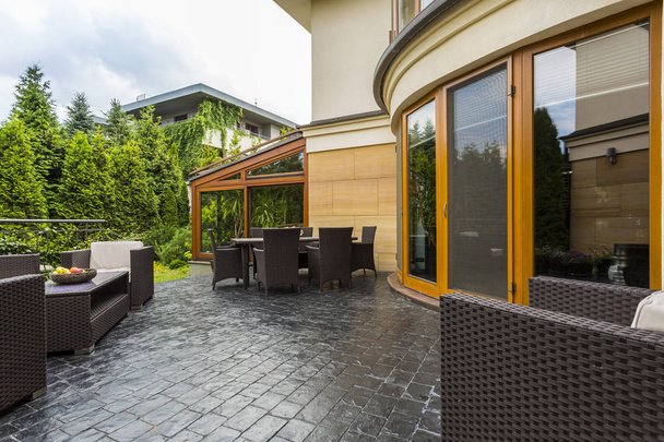 Elegant backyard terrace with rattan furniture - Zdjęcie, obraz