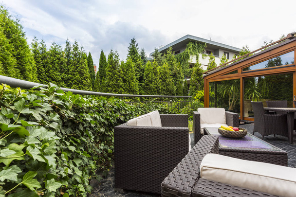 Terrace surrounded by lush garden - Foto, afbeelding