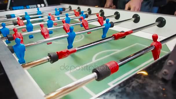 Kick off strike in table football game. Young people playing foosball. Side view - Footage, Video