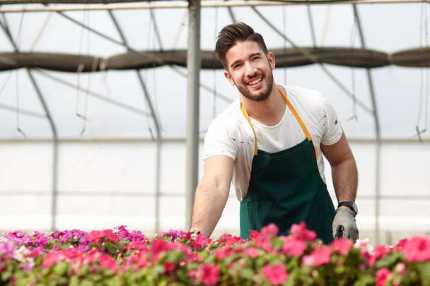 Portrait of a smiling greenhouse worker - Foto, immagini