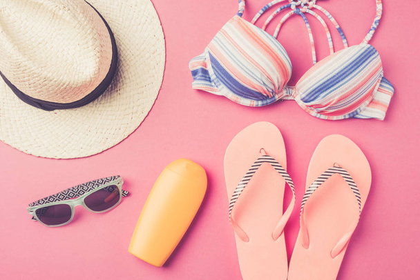 Summer background with straw hat, flip flops, swimsuit and sunglasses - 写真・画像