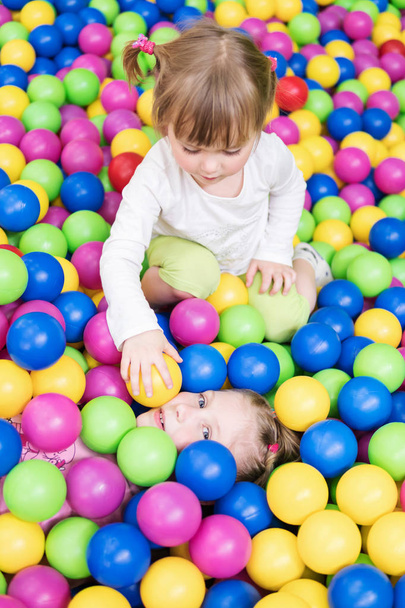 Children play in colorful balls - Fotó, kép