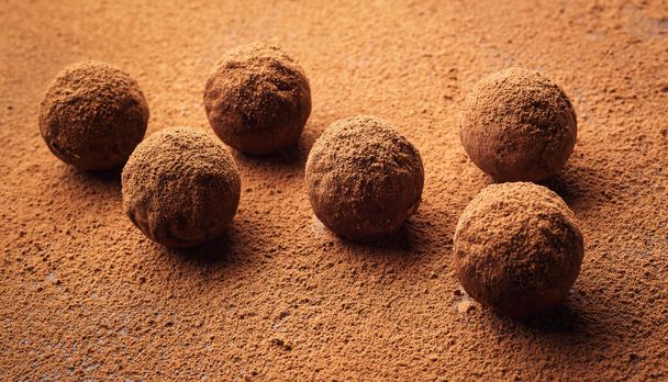 Chocolate truffle, Truffle chocolate candies with cocoa powder.Homemade fresh energy balls with chocolate.Gourmet assorted truffles made by chocolatier.Chunks of chocolate and coffee beans, copy space
 - Фото, изображение