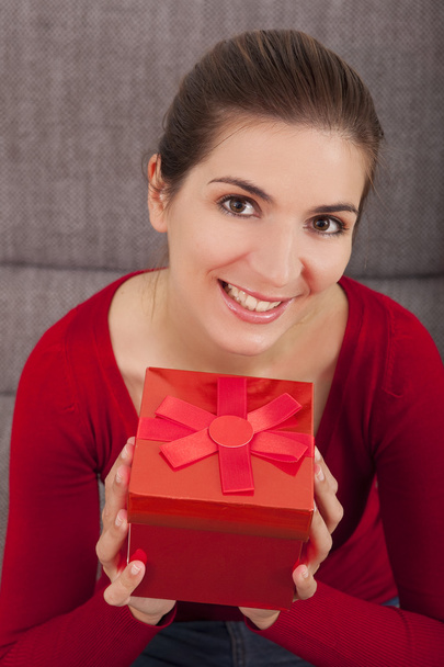 Woman with a christmas present - 写真・画像