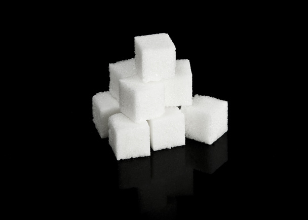 Sugar cubes on black - Photo, Image