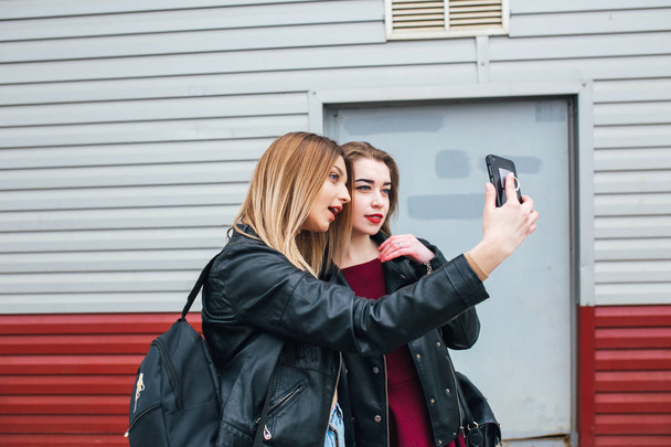 Two young girls taking selfie using smartphone - Fotoğraf, Görsel