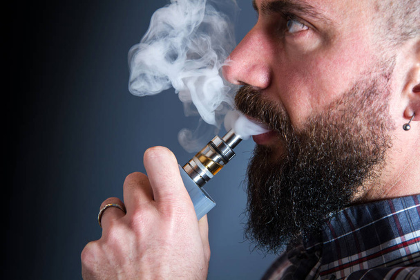 beared man  smoking electronic cigarette - Photo, Image