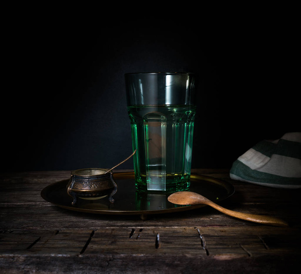 Glass glass with water on a wooden table. Dark background - Photo, image