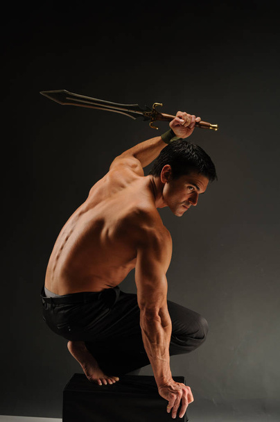 The moody warrior stretches - 写真・画像