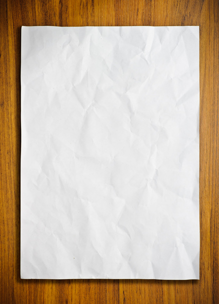 White paper on wood floor - Foto, afbeelding