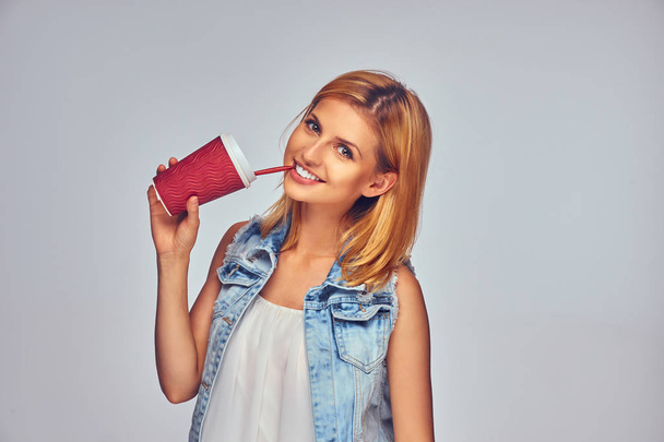 Positive female holds paper red cup - Valokuva, kuva