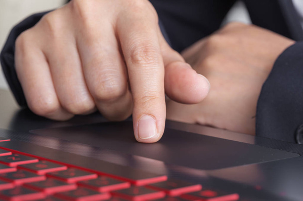 business hand working on a laptop touchpad - Photo, Image