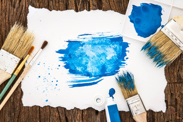Art brush and blue watercolor painted with white paper art  on w - Valokuva, kuva