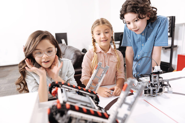 Shocked kids observing electronic robots at school - Φωτογραφία, εικόνα