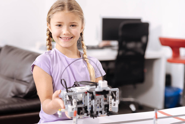 Sincere little girl holding electronic toy at school - Φωτογραφία, εικόνα