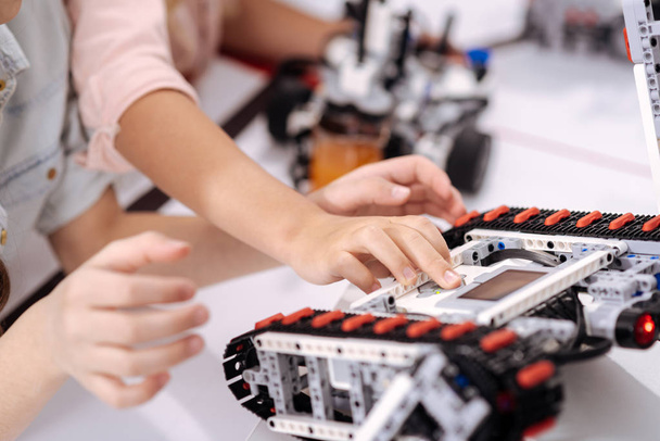 Skilled schoolchildren testing electronic robots at school - Foto, immagini