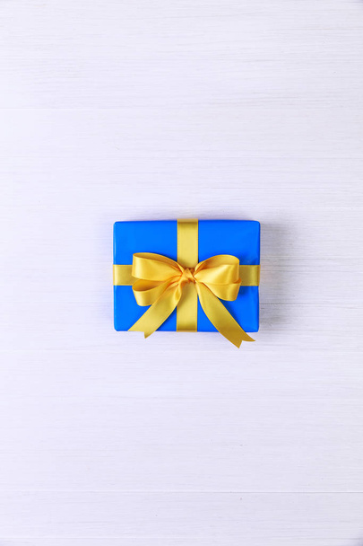 Gift box with yellow bow. Blue present package. - Φωτογραφία, εικόνα