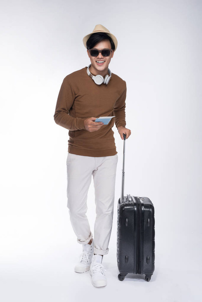 man holding passport standing with suitcase - Φωτογραφία, εικόνα
