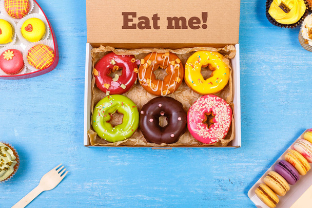 Glazed donuts, cupcakes and macaroons. - Φωτογραφία, εικόνα