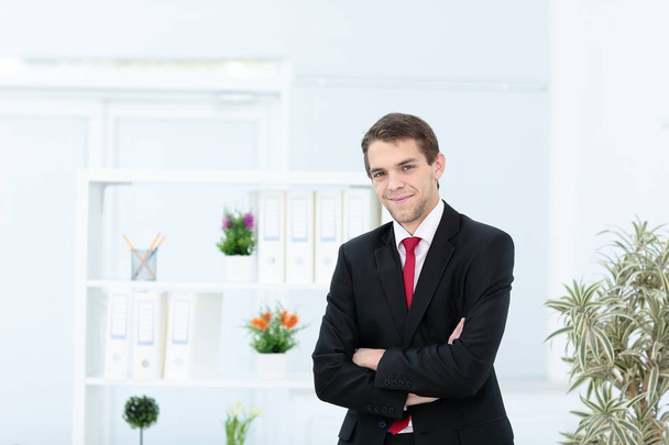 Portrait of happy businessman with arms crossed standing - Photo, Image