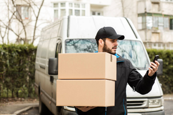 delivery man with cardboard in hands - Fotó, kép