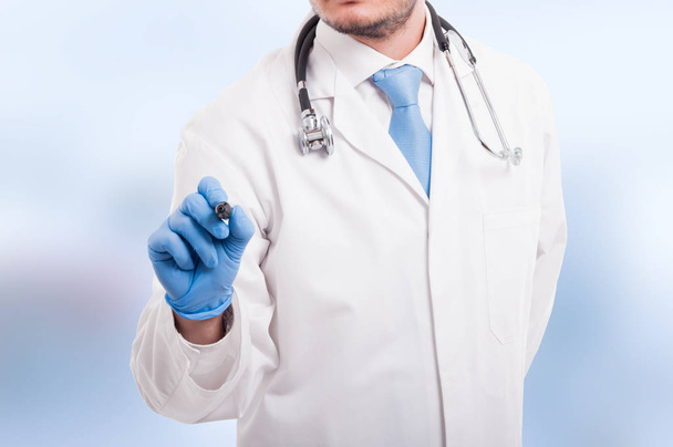 Male doctor writing something with marker - Foto, immagini