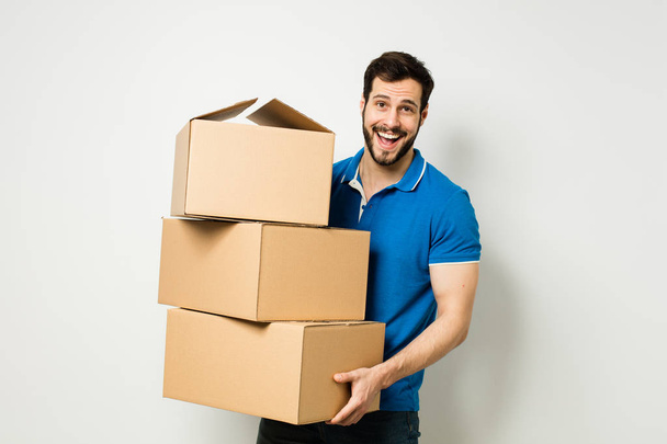 young man with a cardboard box in his arms - Foto, imagen
